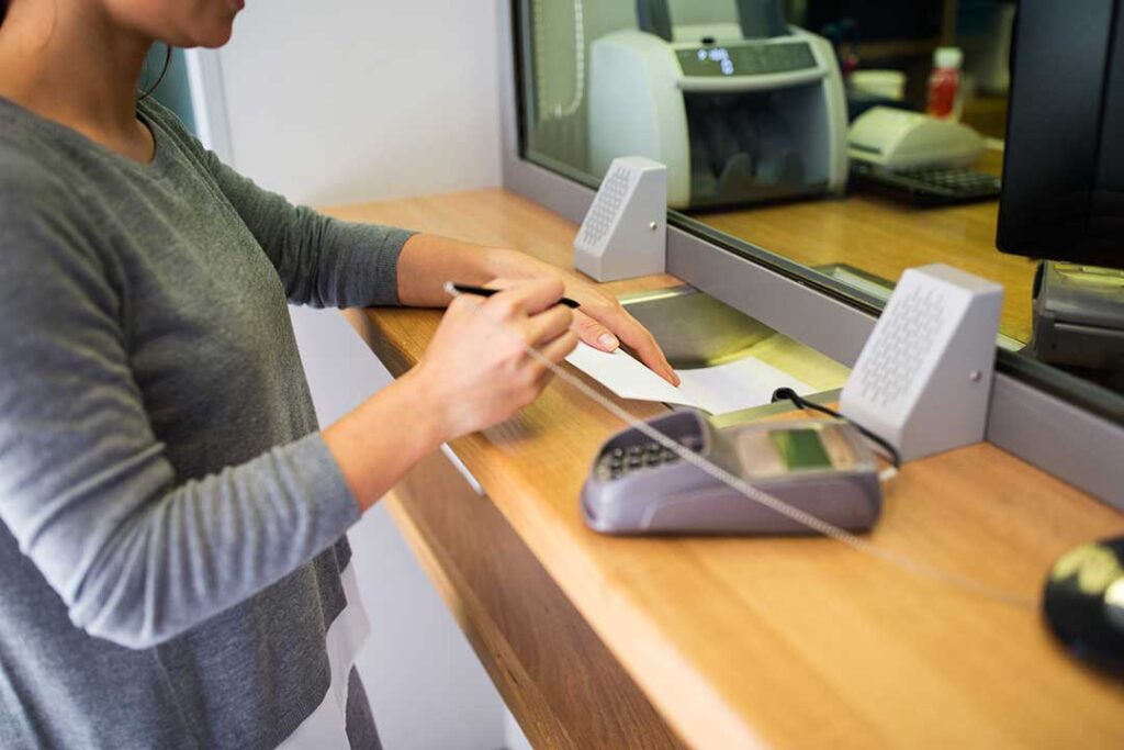 A middle-aged couple reviews retirement account paperwork together at their kitchen table, discussing their options.